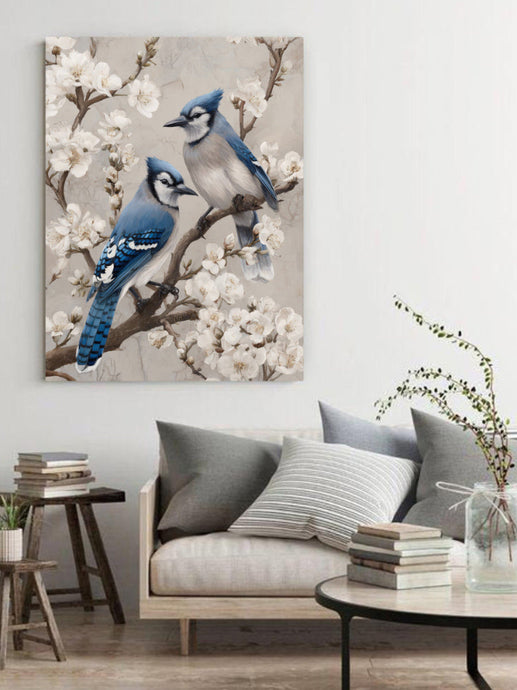 Living room with a painting of two blue birds on a branch above a sofa.
